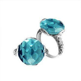Handcrafted Bali sterling silver ring with faceted round Blue Topaz Quartz and scroll-carved band.